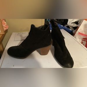 Black suede women’s booties with wooden heel.